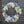 Load image into Gallery viewer, A round funeral wreath with blue and white flowers.