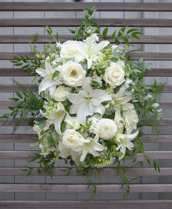 A funeral spray with all white flowers.