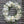 Load image into Gallery viewer, A round funeral wreath with white flowers.