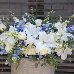 A photo of a white and blue flowers Full Casket Cover for a Funeral.