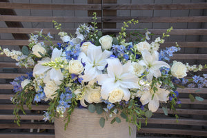 A photo of a white and blue flowers Full Casket Cover for a Funeral.