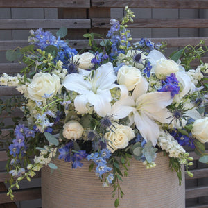 A photo of a white and blue Half Casket Cover for a Funeral.
