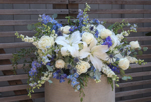 A photo of a white and blue Half Casket Cover for a Funeral.