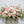A photo of a Full Casket Cover made with white and pale pink flowers.