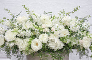 A photo of a Full Casket Cover made with all white flowers.