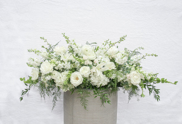 A photo of a Full Casket Cover made with all white flowers.